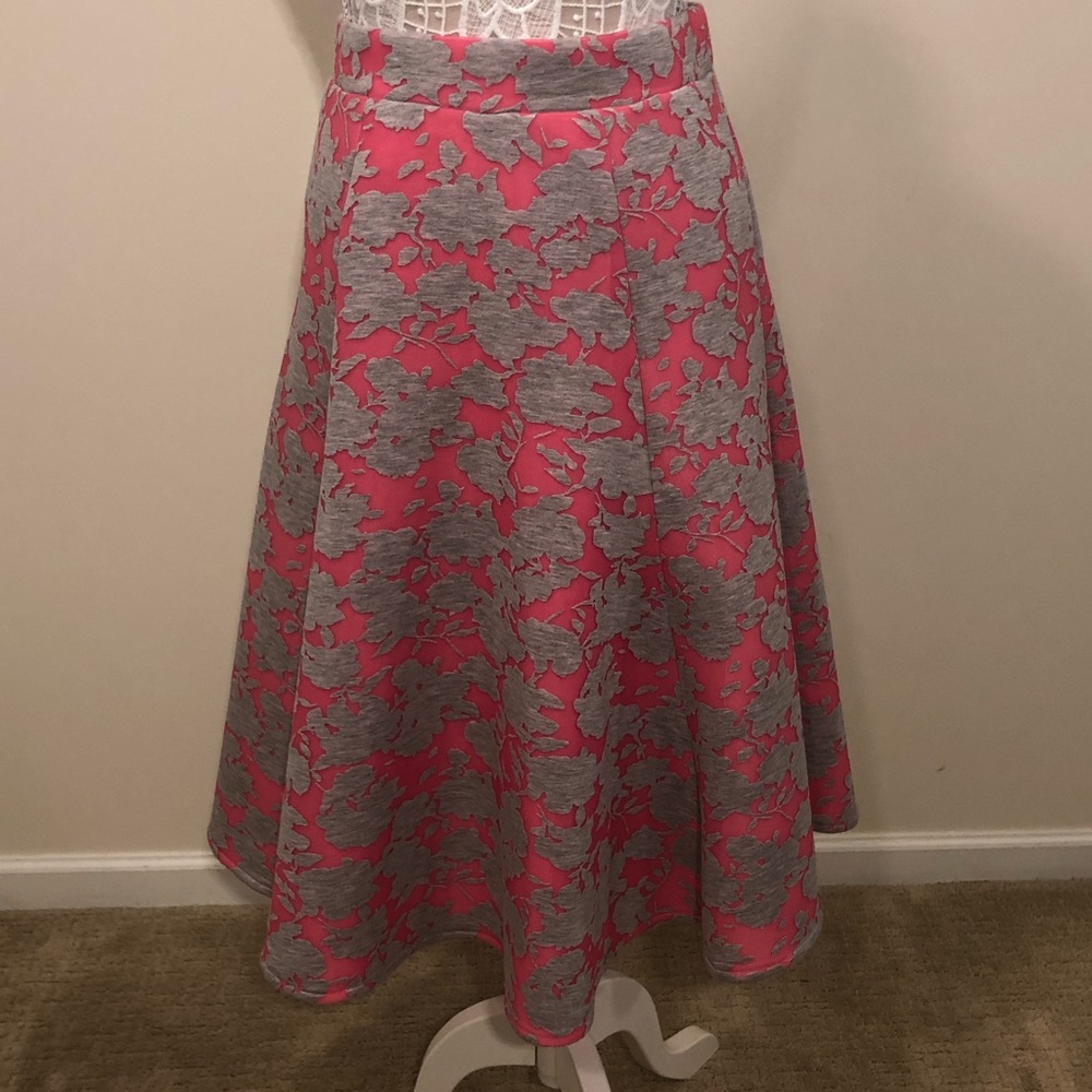 Pink skirt with gray flower print.
